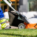 DIY Lawn Care vs. Professional Lawn Services: Pros and Cons Banner Image - Garden worker mowing the lawn