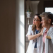 Side view of a healthcare worker or caregiver visiting senior woman indoors at home, helping her to walk.