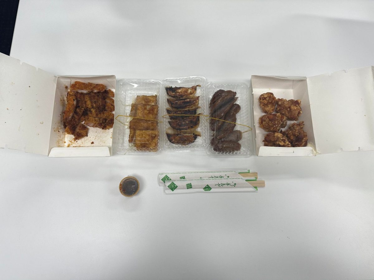Ordered meals from left to right are Katsu, Teriyaki Tofu, Pork Gyoza, Osaka Sausages, and Tatsuta Age