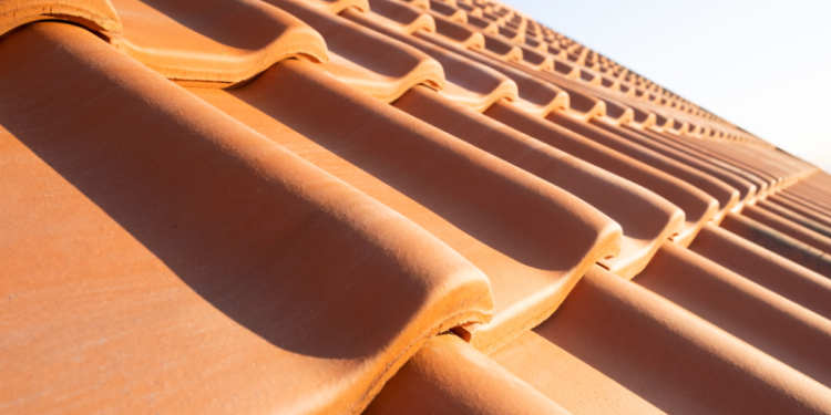 The Impact of Australia's Climate on Optimal Roofing Choices Banner Image - Overlapping rows of yellow ceramic roofing tiles covering residential building roof