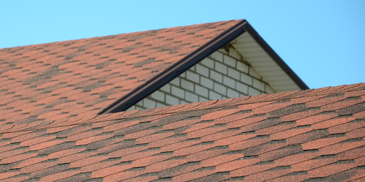 Top Benefits of Investing in a New Roof Banner Image - The roof is covered with bituminous shingles of brown color. Quality Roofing
