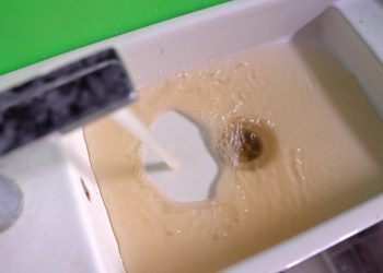 Dirty water flowing in the bathroom closeup footage