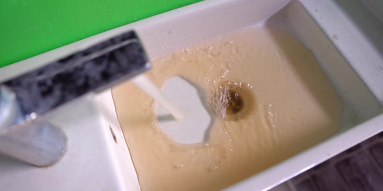 Dirty water flowing in the bathroom closeup footage