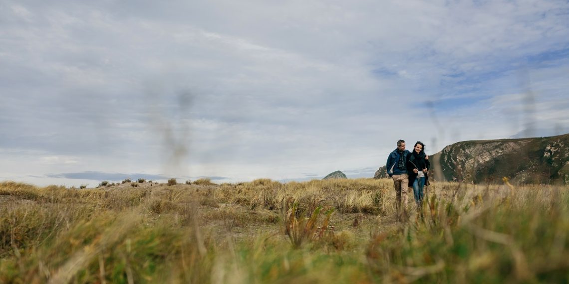 Young couple taking a walk near the coast