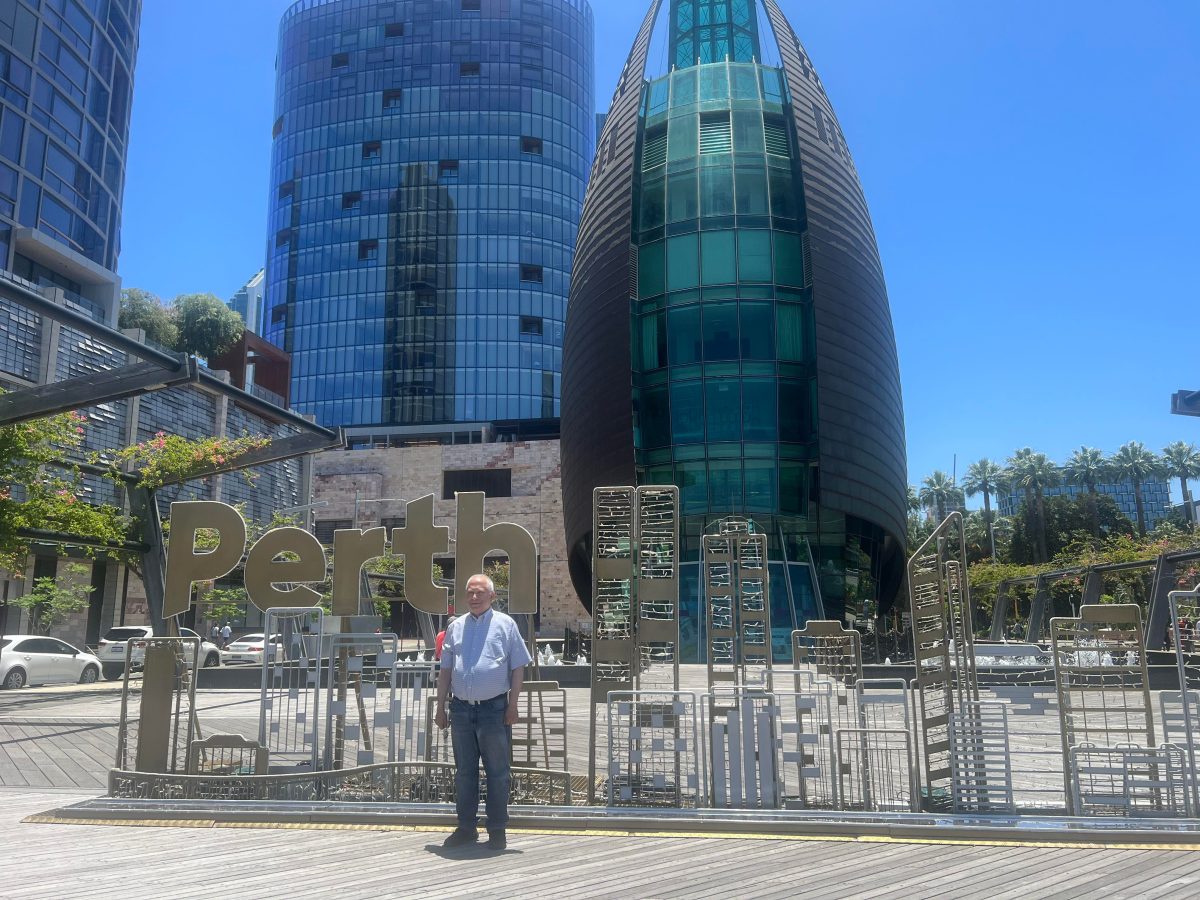 dad in front of giant perth sign