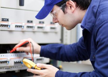 electrician testing power at home