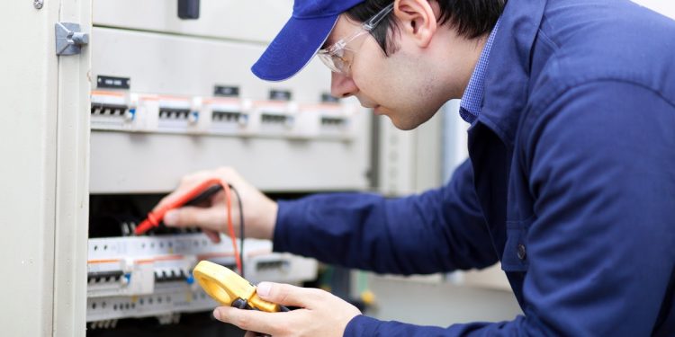 electrician testing power at home