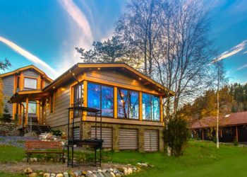 Cottage on the slope. Cottage village. House with large windows. The construction of the mysterious houses. Infrastructure. Living in the country. Wooden house.