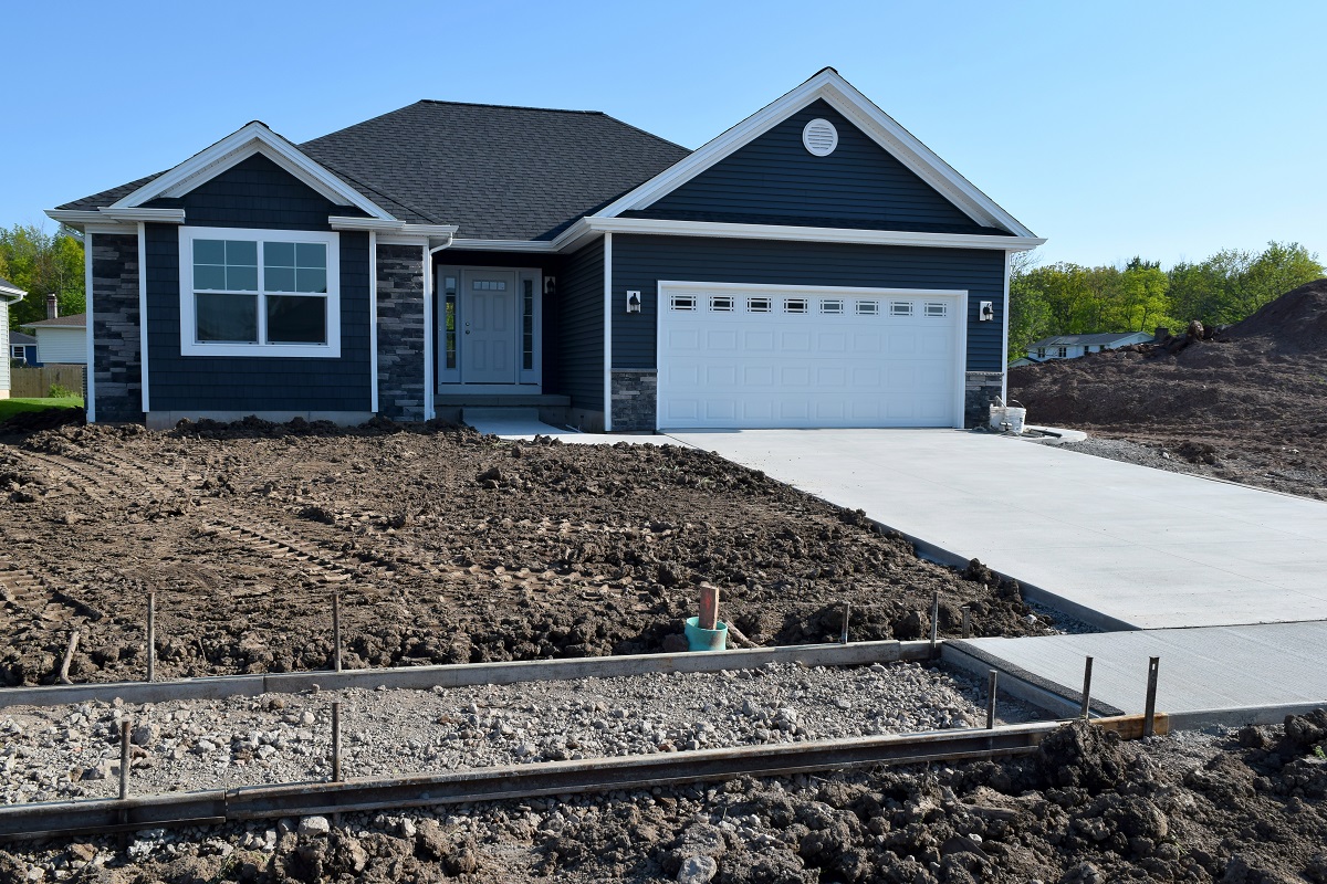 New Home Sidewalk and Driveway Construction with a Concrete Cement Foundation by Builders for a Smooth Surface