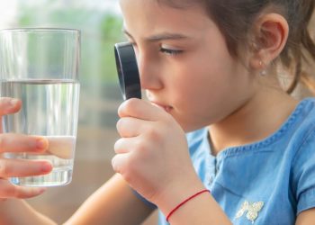 girl looking at glass of water