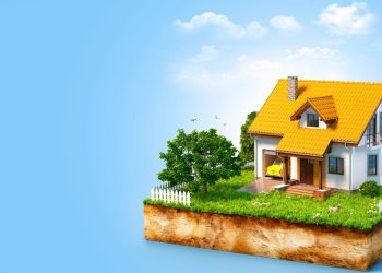 White house on a piece of earth with garden and trees.