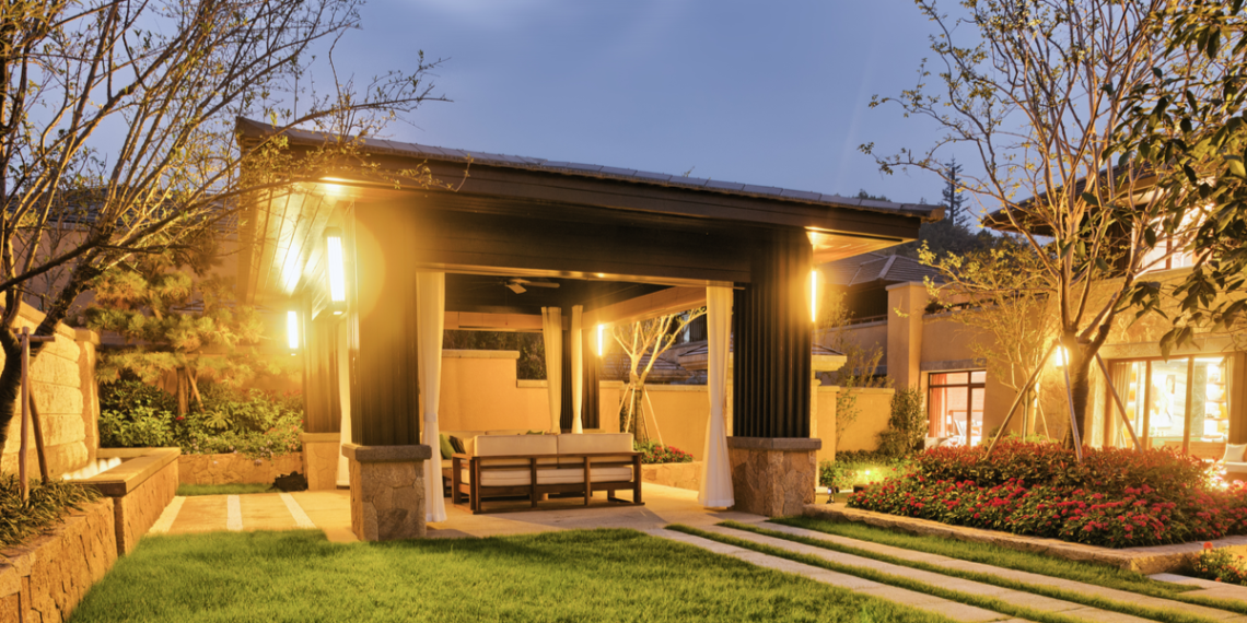 house with outdoor lighting at dusk
