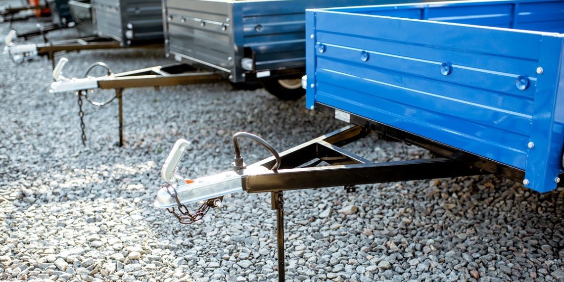 Farm truck trailer on the open ground of the agricultural shop