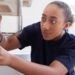 Female Plumber Working To Fix Leaking Sink In Home Bathroom