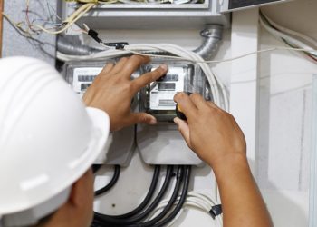 Electrician is repairing and checking electric meters. Close up. Selective focus.