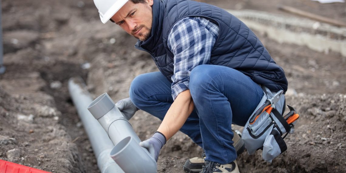 home renovation plumber fixing sewerage pipe at construction sit