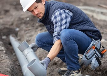 home renovation plumber fixing sewerage pipe at construction sit