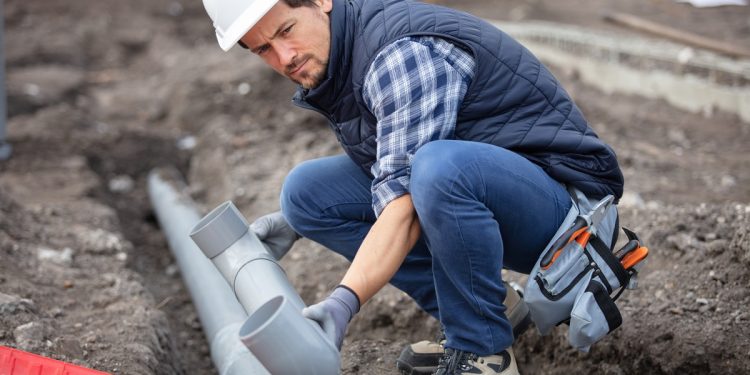 home renovation plumber fixing sewerage pipe at construction sit