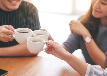 Close up image of three asian people enjoyed drinking and clinki