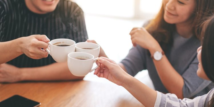 Close up image of three asian people enjoyed drinking and clinki
