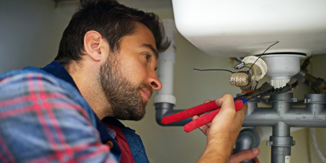 He's a pro at plumbing. Shot of a plumber fixing a pipe