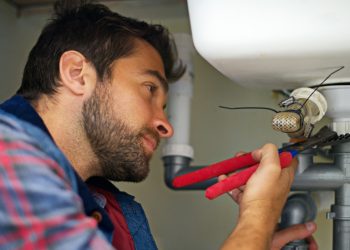He's a pro at plumbing. Shot of a plumber fixing a pipe