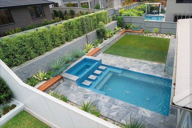 pool in yard with box hedges