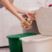 Young girl sorting garbage at the kitchen. Concept of recycling. Zero waste