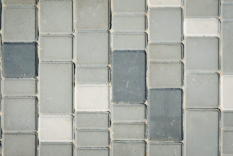 Pavement pattern made with cast concrete blocks in grey color. Texture or background. Top view